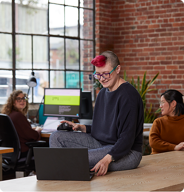 Q30 staff member working on their laptop