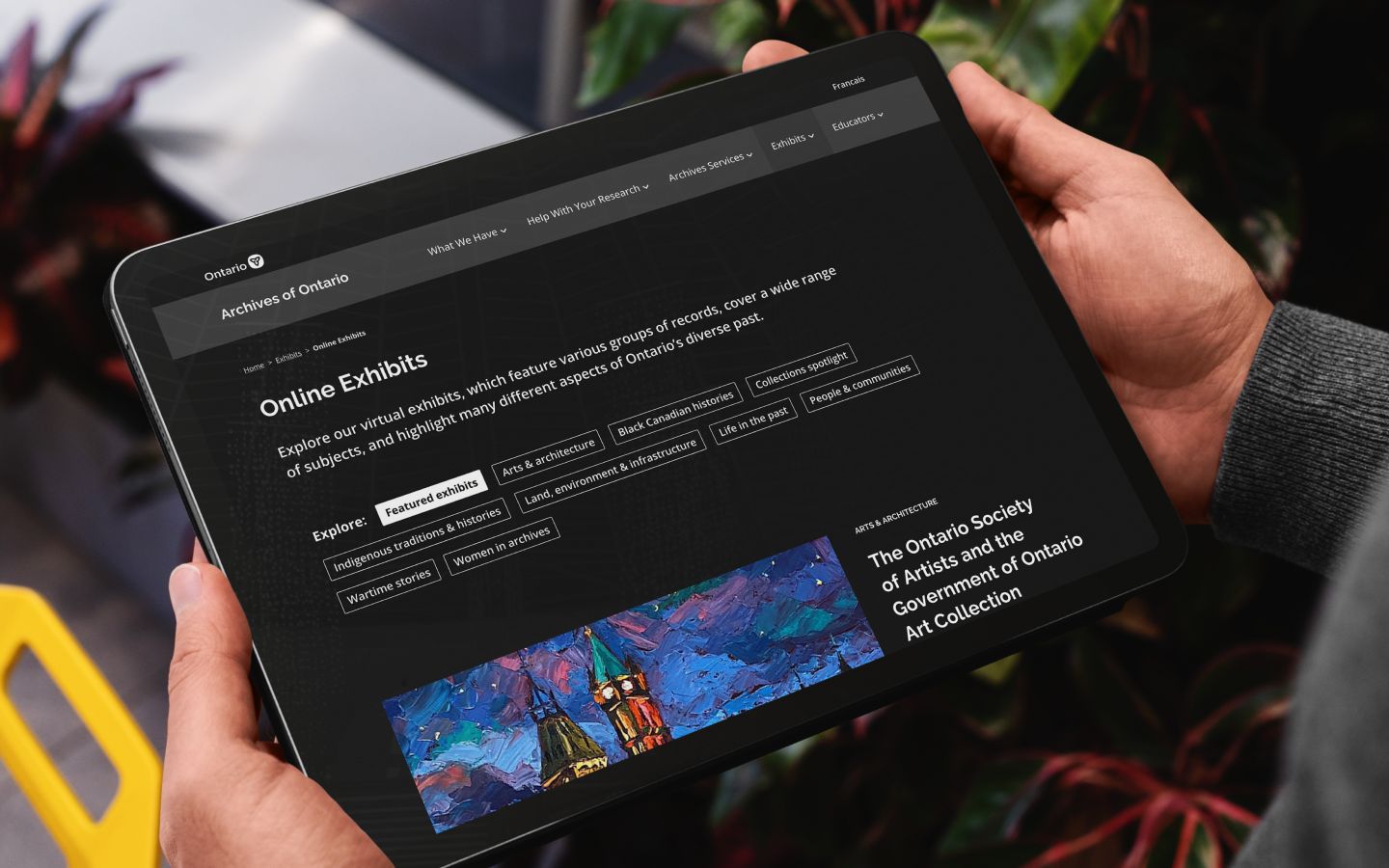 Person on iPad browsing content on Archives of Ontario website